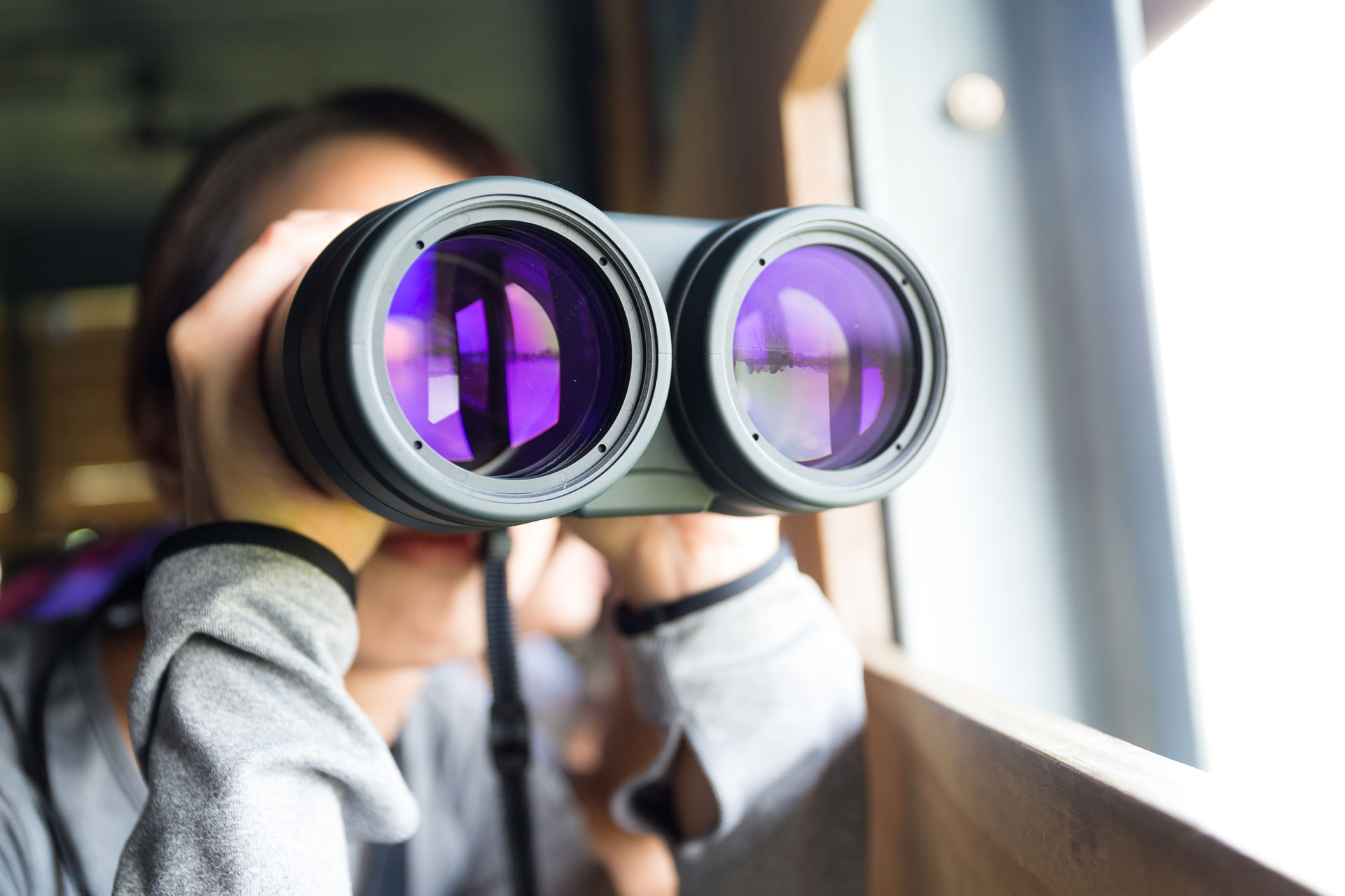student observing weather from trailer with binoculars